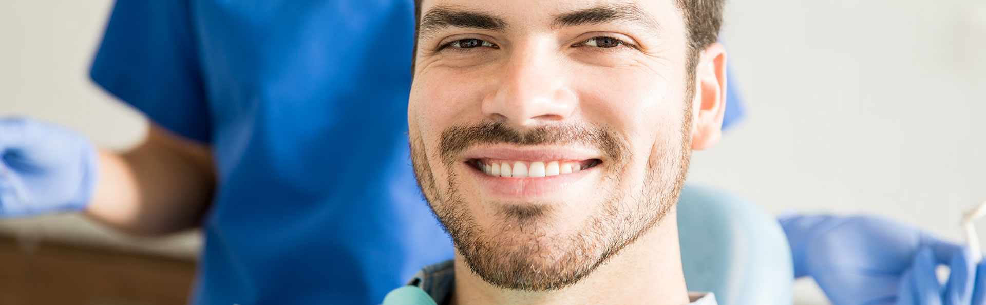 Man smiling after dental crowns treatment