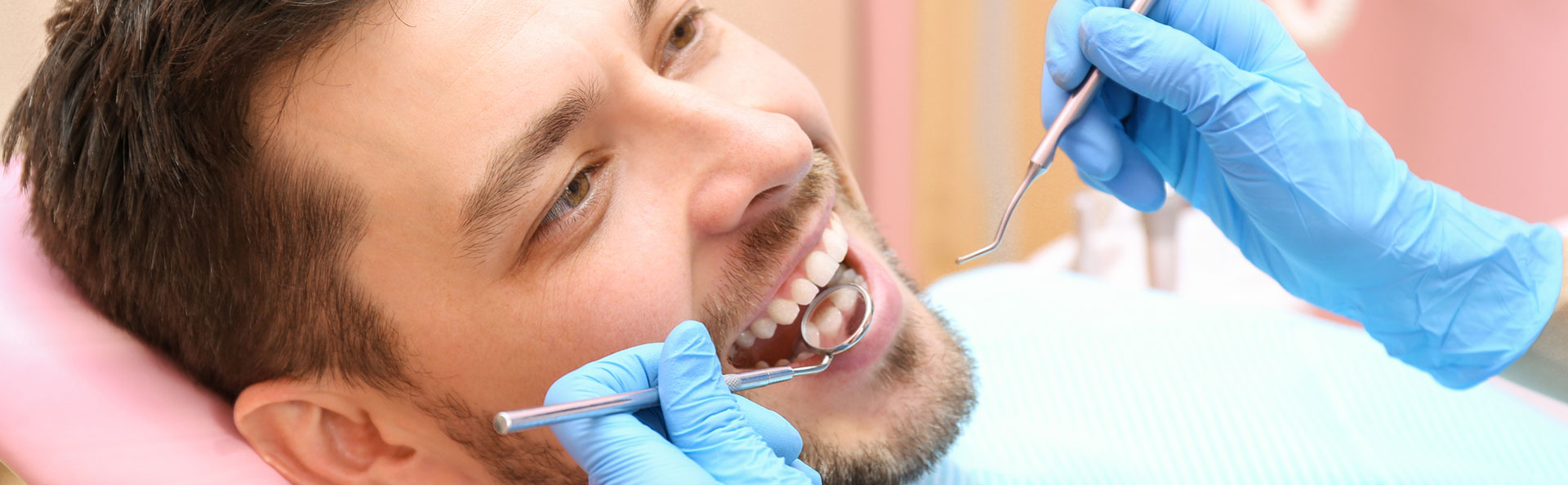 Man having dental exam and teeth cleanings