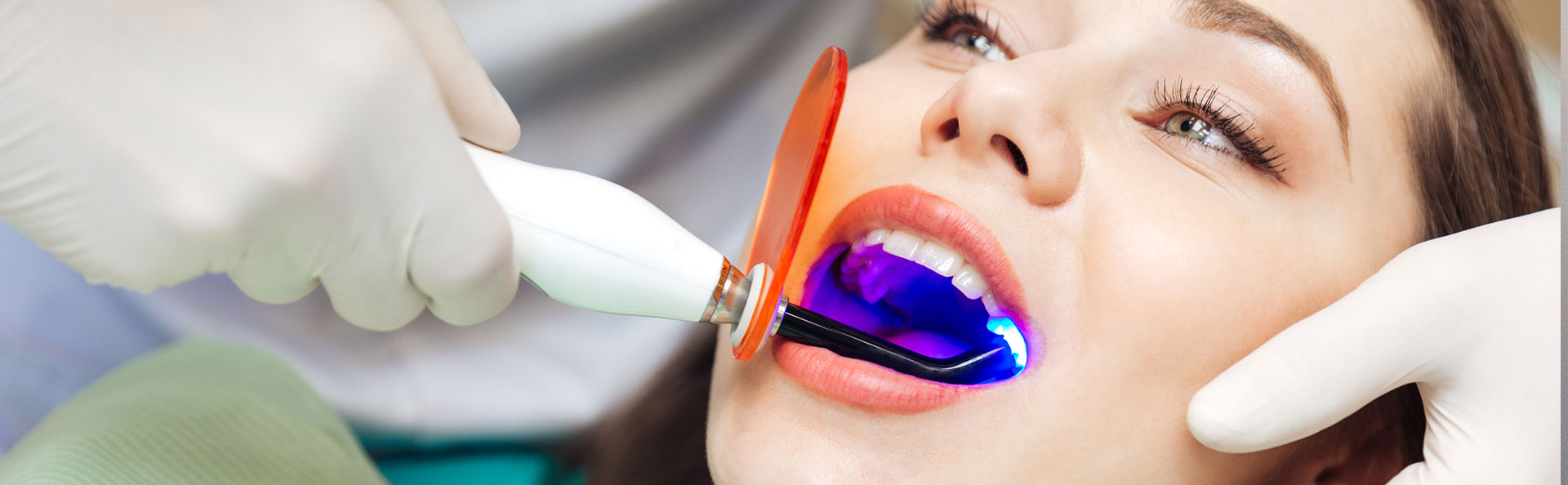 Beautiful woman having laser dentistry